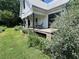 Inviting farmhouse with a charming front porch, rocking chairs, and colorful flower garden at 10975 Hutcheson Ferry Rd, Chattahoochee Hills, GA 30268