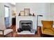 Living room fireplace with white painted brick and classic decorative accents at 10975 Hutcheson Ferry Rd, Chattahoochee Hills, GA 30268
