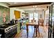 Farmhouse-style kitchen featuring a large island with a wooden countertop, a black oven range, and charming floral wall art at 10975 Hutcheson Ferry Rd, Chattahoochee Hills, GA 30268