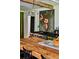 Stylish kitchen featuring a high-end oven range, a large island, green cabinets, and a unique floral wall at 10975 Hutcheson Ferry Rd, Chattahoochee Hills, GA 30268