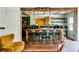 Open concept kitchen with eat-in island and green lower cabinetry with open shelving at 10975 Hutcheson Ferry Rd, Chattahoochee Hills, GA 30268