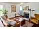 Cozy living room with white shiplap walls, fireplace, and a stylish patterned rug at 10975 Hutcheson Ferry Rd, Chattahoochee Hills, GA 30268