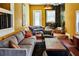 Well-appointed living room with ample seating, wood-burning stove, exposed brick floor and unique decor at 10975 Hutcheson Ferry Rd, Chattahoochee Hills, GA 30268