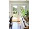 Living room view featuring French doors, wood floors, and a comfortable leather couch at 10975 Hutcheson Ferry Rd, Chattahoochee Hills, GA 30268