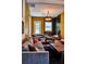 Cozy living room features comfortable seating, a wood-burning stove, exposed brick floor and unique decor at 10975 Hutcheson Ferry Rd, Chattahoochee Hills, GA 30268