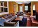 Cozy living room features a gray sofa, armchairs, wood-burning stove, and unique decor, creating a warm and inviting atmosphere at 10975 Hutcheson Ferry Rd, Chattahoochee Hills, GA 30268