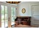 Bright office area with writing desk and beautiful backyard view through the French door at 10975 Hutcheson Ferry Rd, Chattahoochee Hills, GA 30268