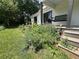 Inviting covered porch featuring a swing, beautiful blue flowers, and a peaceful place to enjoy the surroundings at 10975 Hutcheson Ferry Rd, Chattahoochee Hills, GA 30268