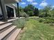 Charming farmhouse with a lush garden, cozy porch, and inviting outdoor space at 10975 Hutcheson Ferry Rd, Chattahoochee Hills, GA 30268