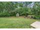 Backyard features ample lawn space, shed, patio and peaceful wooded setting at 101 Constance Dr, Locust Grove, GA 30248