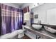 Bathroom features a unique vessel sink, sleek tile, and a stylish purple shower curtain at 101 Constance Dr, Locust Grove, GA 30248