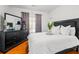 Well-lit bedroom showcasing a black dresser, plush pillows, and a large mirror at 101 Constance Dr, Locust Grove, GA 30248