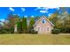Brick house with a large front yard and mature trees at 101 Constance Dr, Locust Grove, GA 30248