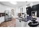 Modern kitchen with stainless steel appliances, white cabinets, and a kitchen island with bar stool seating at 101 Constance Dr, Locust Grove, GA 30248