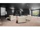 Spacious living room with stylish seating, dark accents, and abundant natural light at 101 Constance Dr, Locust Grove, GA 30248