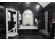 Elegant main bathroom with a standalone tub, black tile, walk-in shower, and luxurious finishes at 101 Constance Dr, Locust Grove, GA 30248