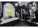 Stylish bathroom featuring a soaking tub, walk-in shower, dark walls, and modern fixtures at 101 Constance Dr, Locust Grove, GA 30248