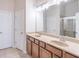 Double vanity bathroom with beige countertop and large mirror at 822 Northam Ln, Atlanta, GA 30342
