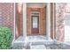 Brown front door with sidelights and a brick surround at 822 Northam Ln, Atlanta, GA 30342