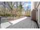 Snow covered deck with gray railings and wooded views at 1483 Hidden Hills Pkwy, Stone Mountain, GA 30088