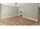 Light-filled dining room with hardwood floors and modern light fixture at 1483 Hidden Hills Pkwy, Stone Mountain, GA 30088