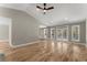 Open living area with hardwood floors, vaulted ceilings and sliding glass doors at 1483 Hidden Hills Pkwy, Stone Mountain, GA 30088