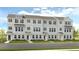 Three-story townhouses with brick facade and landscaped yards at 220 Maycrest Path, Tucker, GA 30084