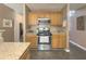 Kitchen with stainless steel appliances and oak cabinets at 690 Winding River Dr, Lawrenceville, GA 30046