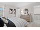 Bright bedroom with dresser, large bed, and access to upper level at 7175 Linden Dr, South Fulton, GA 30349