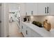 Butlers pantry with white cabinets, quartz countertops and herringbone backsplash at 7175 Linden Dr, South Fulton, GA 30349