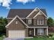 Two-story brick home with a three-car garage and landscaping at 7175 Linden Dr, South Fulton, GA 30349