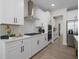 White kitchen with herringbone backsplash and stainless steel appliances at 7175 Linden Dr, South Fulton, GA 30349