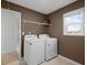 Convenient laundry room with washer, dryer, and overhead shelving at 7175 Linden Dr, South Fulton, GA 30349