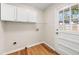 Laundry room with white cabinets and backyard access at 1110 Neva Dr, Marietta, GA 30060