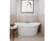 Free-standing bathtub with modern fixtures and artwork at 1731 N Springs Dr, Dunwoody, GA 30338