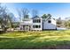 White two story house with a large backyard and screened porch at 1731 N Springs Dr, Dunwoody, GA 30338