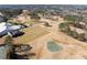 Aerial view of golf course, clubhouse, and tennis courts at 110 Pro Ter, Johns Creek, GA 30097