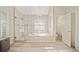 Spa-like bathroom featuring a soaking tub, walk-in shower, and large window at 110 Pro Ter, Johns Creek, GA 30097