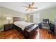 Comfortable bedroom with hardwood floors and built-in workspace at 110 Pro Ter, Johns Creek, GA 30097