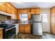 Kitchen with wood cabinets, stainless steel appliances, and tiled countertops at 190 Highland Blvd, Stockbridge, GA 30281