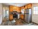 Kitchen with wood cabinets, stainless steel appliances, and tiled countertops at 190 Highland Blvd, Stockbridge, GA 30281