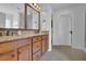 Double vanity bathroom with granite countertops and large mirrors at 555 Winder Trl, Canton, GA 30114