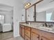 Double vanity bathroom with granite countertops and large mirrors at 555 Winder Trl, Canton, GA 30114