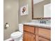 Small bathroom with granite countertop and wood cabinets at 555 Winder Trl, Canton, GA 30114