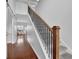 Elegant staircase with a wood railing and carpeted steps at 555 Winder Trl, Canton, GA 30114