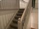 Indoor staircase with carpeted steps and white railings at 3971 Busby Mill Ct, Ellenwood, GA 30294