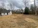 Spacious backyard featuring a quaint house, natural landscaping, and plenty of room to roam at 1938 Highway 212 Sw, Conyers, GA 30094