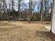 Backyard featuring a stone firepit area and wooded perimeter at 1938 Highway 212 Sw, Conyers, GA 30094