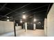 Spacious unfinished basement with exposed ceiling, offering ample storage at 1938 Highway 212 Sw, Conyers, GA 30094