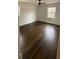 Bright bedroom featuring hardwood floors, white walls, a ceiling fan, and natural light at 1938 Highway 212 Sw, Conyers, GA 30094